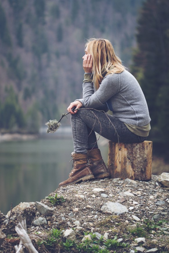 woman-meditating-on-a-lake-shore-PF24HBJ.jpg